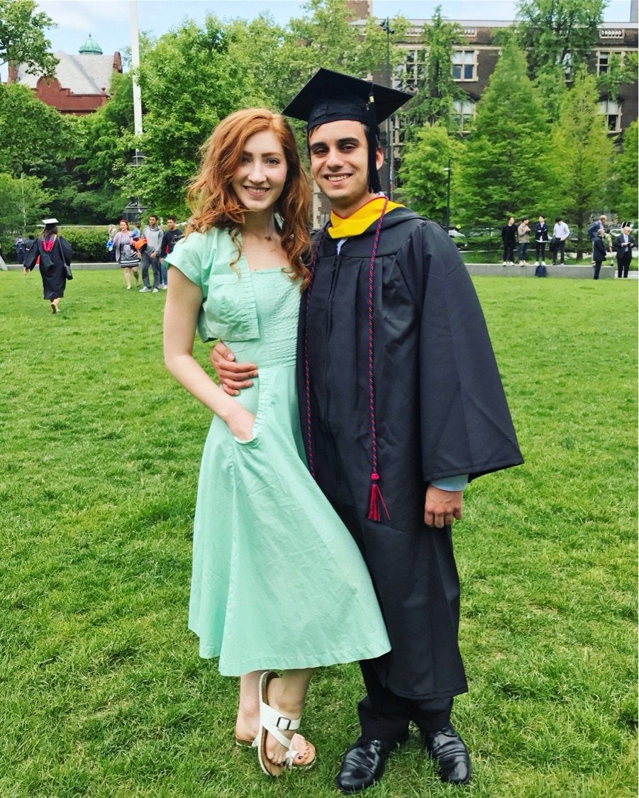 Graduation portrait on a university lawn, Melissa in mint dress with boyfriend in cap and gown