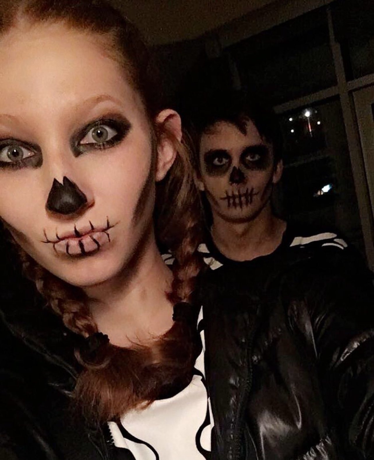 Skeleton-makeup couple selfie at night
