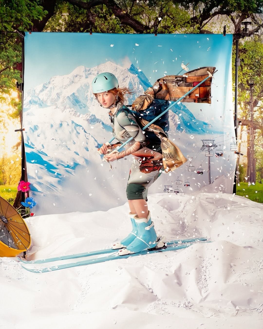 Editorial shoot in ski gear on a fake-snow studio set with a mountain backdrop