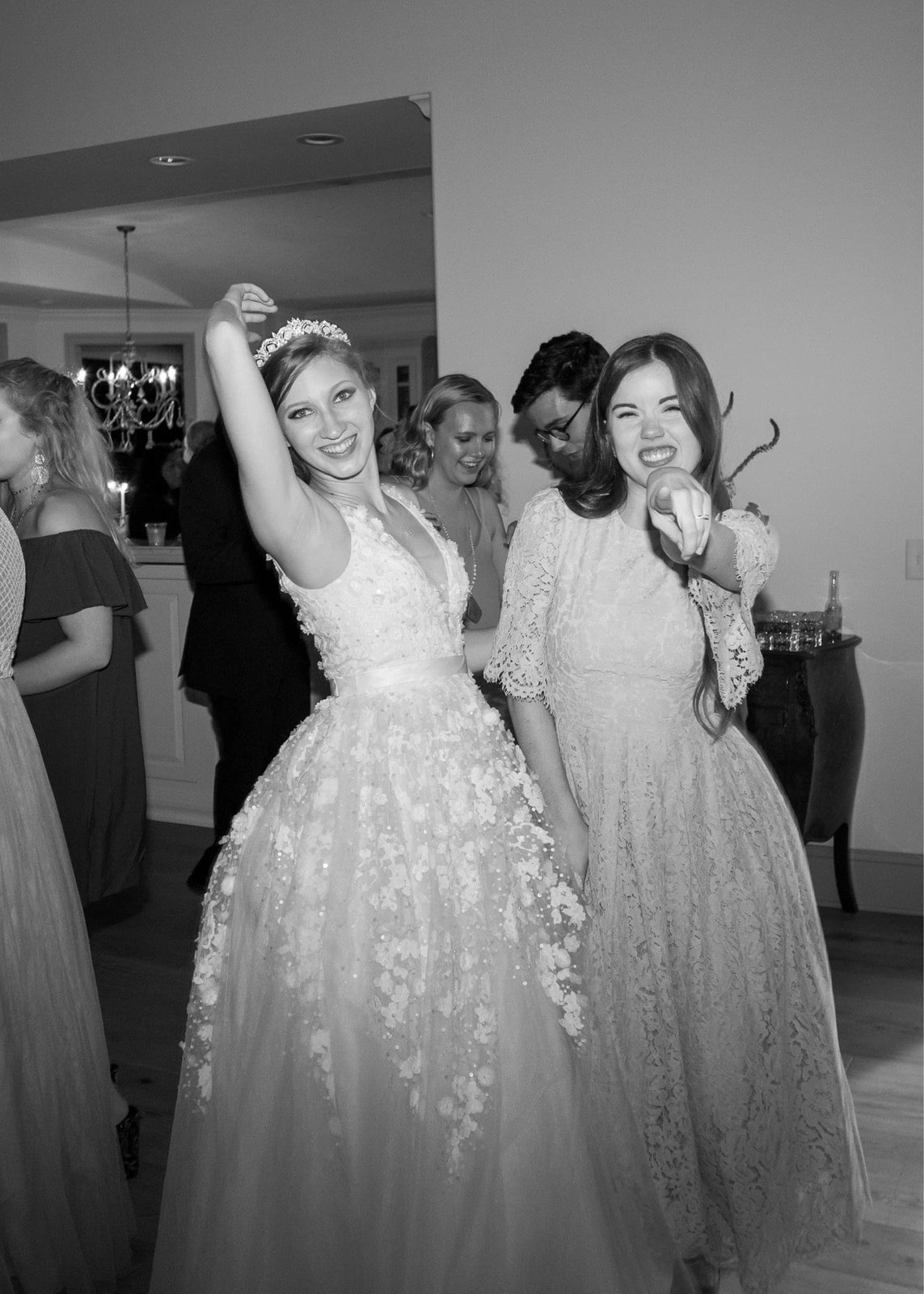 Black and white reception candid mid-dance with a friend
