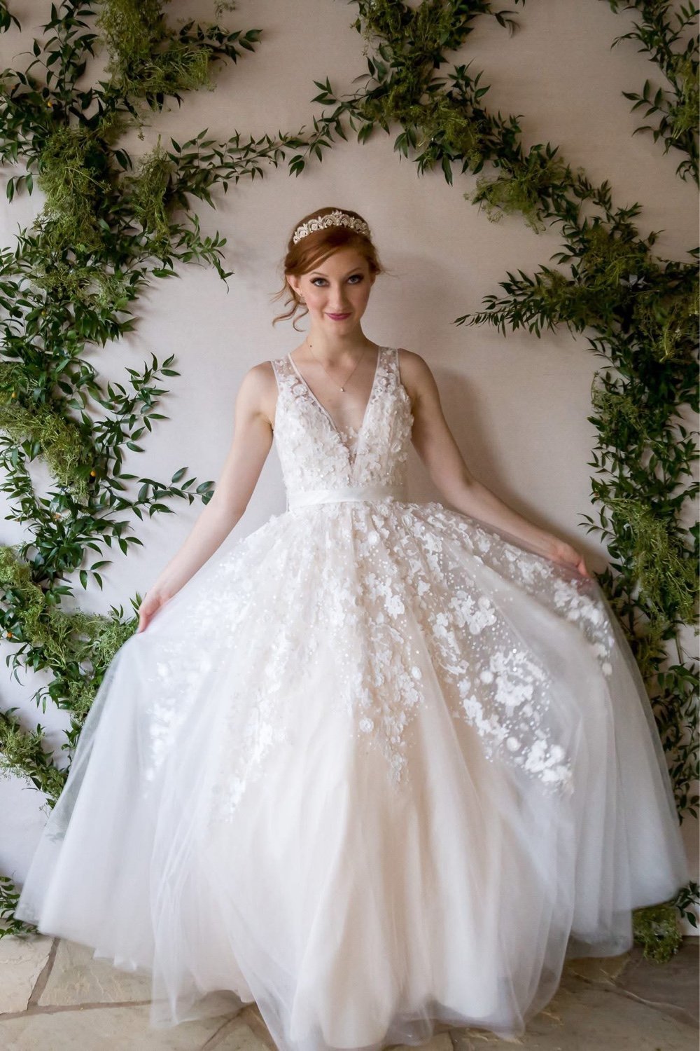 Bridal portrait against a wall of green eucalyptus garlands